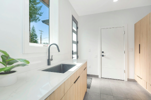 A remodeled bathroom with a sink and window visible.