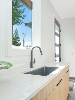 A remodeled bathroom with a sink and window visible.