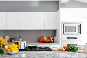 A clean, modern kitchen with white cabinets and granite countertops.