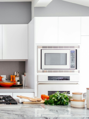 A clean, modern kitchen with white cabinets and granite countertops.